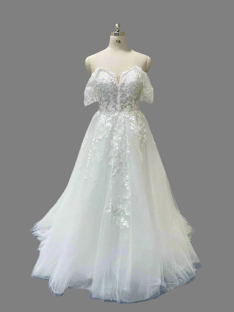 White lace dress on a mannequin against a gray background